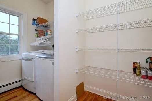 41 Mesa Dr, Bethany, CT 06524 - washroom featuring a baseboard heating unit, washing machine and clothes dryer, and wood finished floors