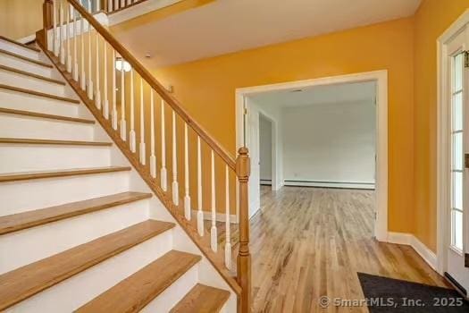 41 Mesa Dr, Bethany, CT 06524 - staircase with a baseboard heating unit and wood finished floors