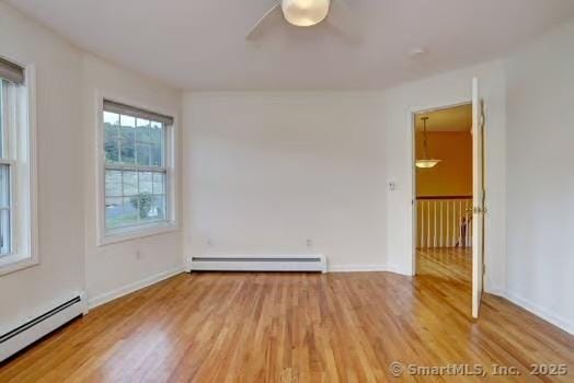 41 Mesa Dr, Bethany, CT 06524 - spare room featuring baseboard heating, a baseboard heating unit, wood finished floors, and a ceiling fan