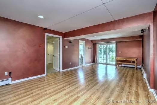 41 Mesa Dr, Bethany, CT 06524 - unfurnished living room featuring wood finished floors, a baseboard heating unit, and recessed lighting