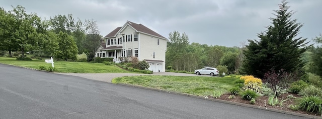 41 Mesa Dr, Bethany, CT 06524 - view of property exterior featuring an attached garage, concrete driveway, and a yard