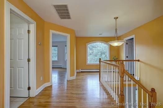 41 Mesa Dr, Bethany, CT 06524 - corridor with an upstairs landing, a baseboard heating unit, and plenty of natural light