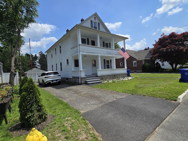 64 Pine St, Torrington, CT 06790 - view of front of property with covered porch, a front yard, a chimney, and a balcony