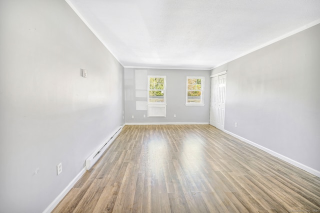 50 Angel Dr Apt D, Waterbury, CT 06708 - spare room with a baseboard heating unit, wood finished floors, and ornamental molding