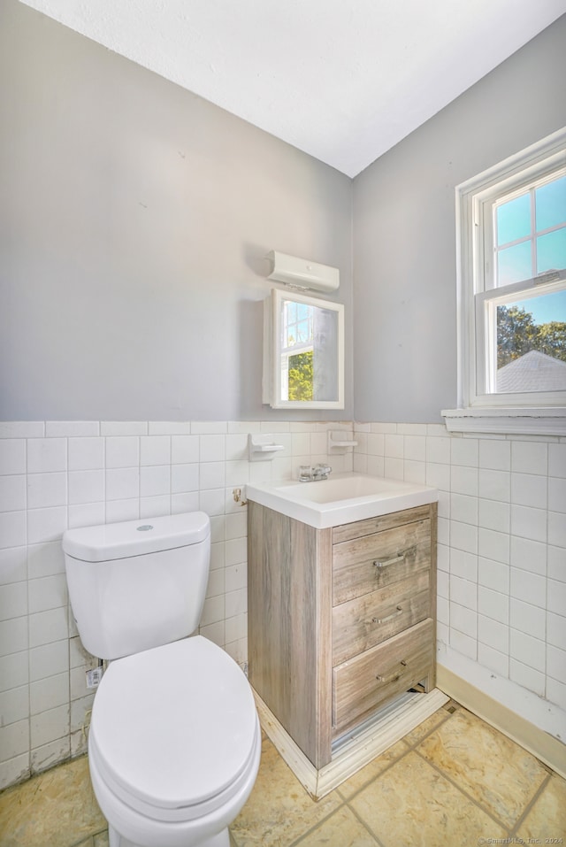 50 Angel Dr Apt D, Waterbury, CT 06708 - half bath featuring tile walls, vanity, and a wainscoted wall
