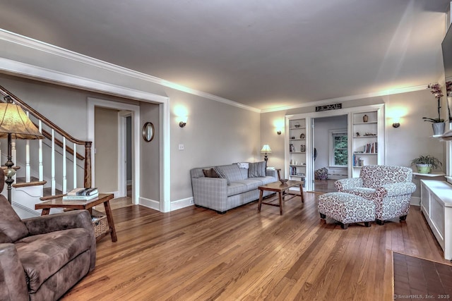 345 Spring St, Cheshire, CT 06410 - living area featuring hardwood / wood-style flooring, ornamental molding, built in shelves, and stairs
