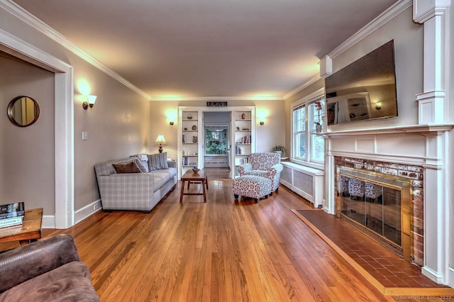 345 Spring St, Cheshire, CT 06410 - living area featuring hardwood / wood-style flooring, radiator, a tile fireplace, and ornamental molding