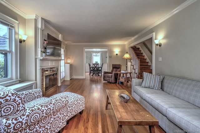 345 Spring St, Cheshire, CT 06410 - living room with wood finished floors, stairway, a fireplace with flush hearth, a chandelier, and ornamental molding