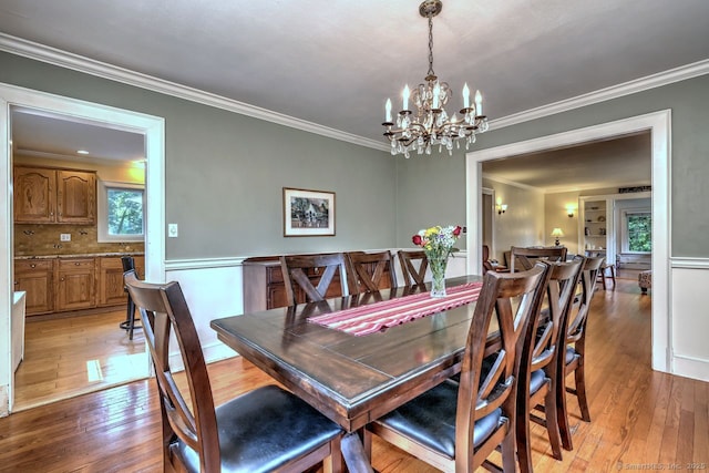 345 Spring St, Cheshire, CT 06410 - dining area featuring light wood-type flooring, plenty of natural light, a chandelier, and crown molding