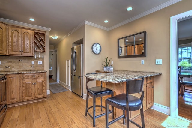345 Spring St, Cheshire, CT 06410 - kitchen featuring appliances with stainless steel finishes, light wood finished floors, tasteful backsplash, recessed lighting, and light stone counters