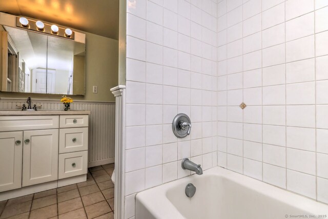 345 Spring St, Cheshire, CT 06410 - full bath with vanity, tile patterned floors, a wainscoted wall, and tub / shower combination
