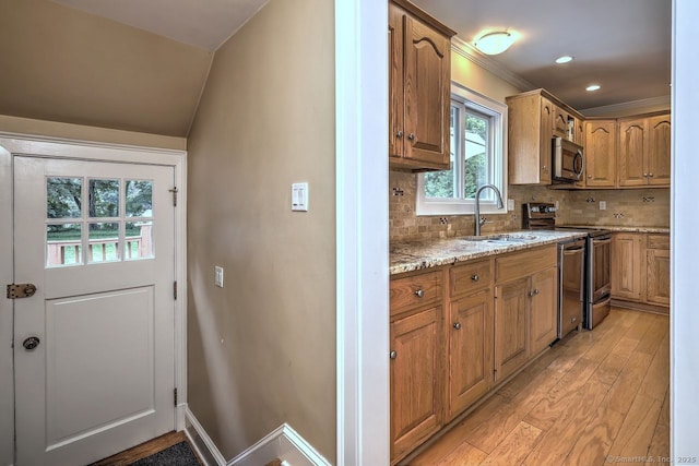 345 Spring St, Cheshire, CT 06410 - kitchen with appliances with stainless steel finishes, light wood-style flooring, light stone countertops, tasteful backsplash, and brown cabinets