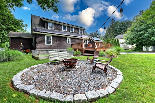 345 Spring St, Cheshire, CT 06410 - rear view of property featuring a fire pit, a deck, a lawn, and roof with shingles