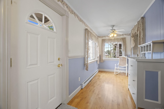169 Peck Ave, West Haven, CT 06516 - foyer featuring baseboard heating, wainscoting, light wood-style flooring, and ceiling fan