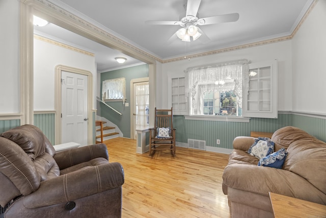 169 Peck Ave, West Haven, CT 06516 - living area with wainscoting, ornamental molding, wood finished floors, a ceiling fan, and stairway