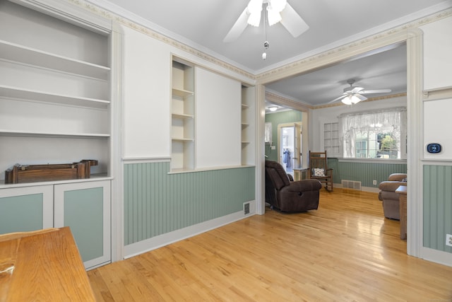 169 Peck Ave, West Haven, CT 06516 - living area with a ceiling fan, light wood-type flooring, crown molding, wainscoting, and built in features
