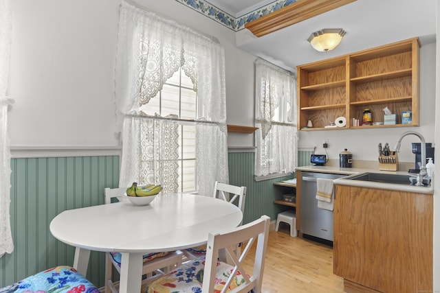 169 Peck Ave, West Haven, CT 06516 - kitchen featuring stainless steel dishwasher, light wood-type flooring, light countertops, wallpapered walls, and open shelves