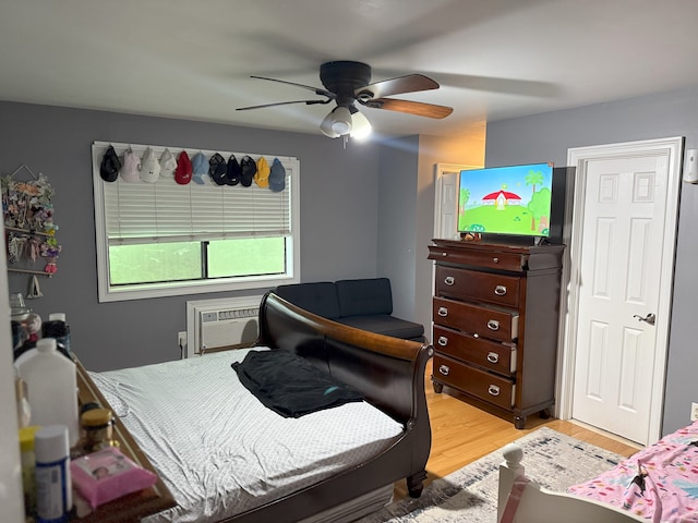 38 Padanaram Ave Unit 24, Danbury, CT 06811 - bedroom featuring light wood-style floors, a wall mounted AC, and a ceiling fan