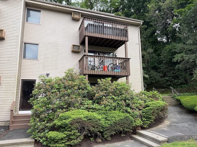 38 Padanaram Ave Unit 24, Danbury, CT 06811 - rear view of property featuring a balcony, a wall mounted AC, and entry steps