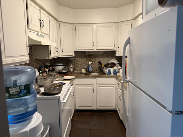 38 Padanaram Ave Unit 24, Danbury, CT 06811 - kitchen featuring white appliances, under cabinet range hood, dark tile patterned floors, white cabinets, and backsplash