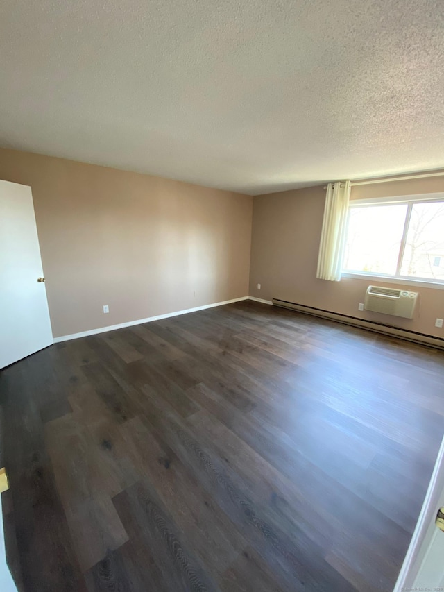 255 Strawberry Hill Ave Unit D4, Stamford, CT 06902 - empty room with a baseboard radiator, dark wood finished floors, a textured ceiling, and a wall mounted AC