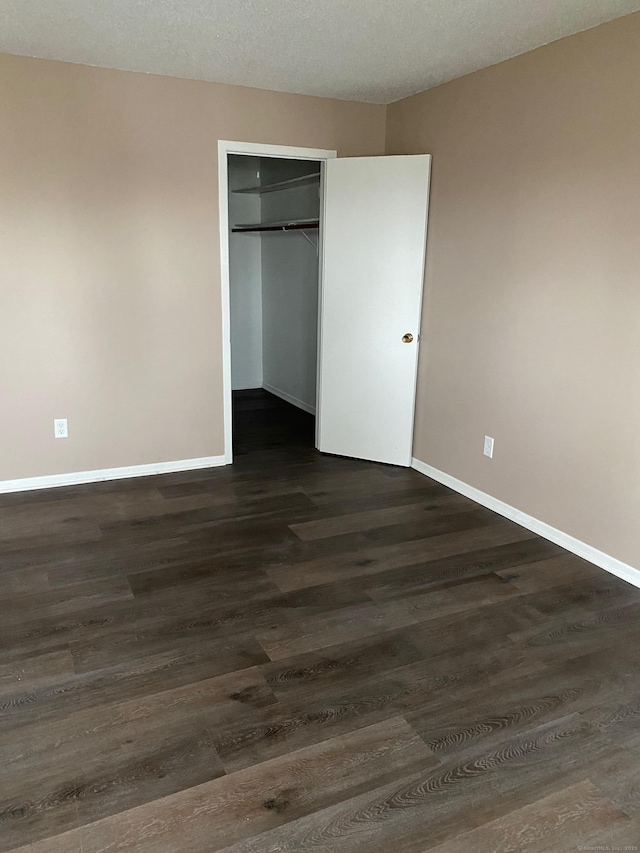 255 Strawberry Hill Ave Unit D4, Stamford, CT 06902 - unfurnished bedroom featuring dark wood-type flooring and a closet