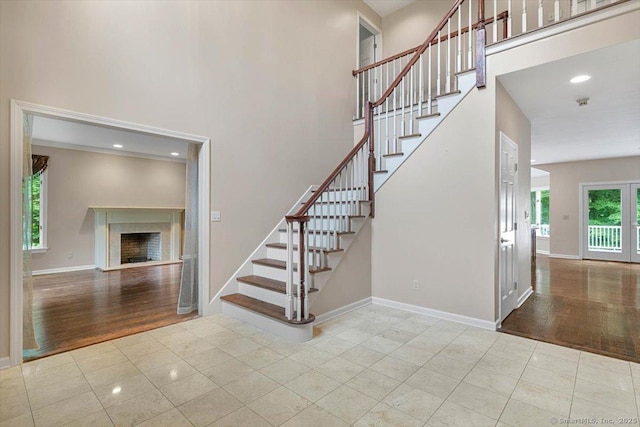 1 Mountaincrest Dr, Cheshire, CT 06410 - stairway with tile patterned flooring, a towering ceiling, and a fireplace