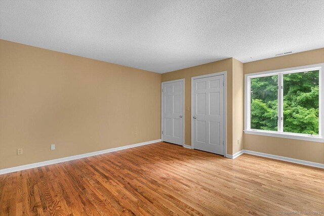 1 Mountaincrest Dr, Cheshire, CT 06410 - unfurnished bedroom with light wood finished floors and a textured ceiling