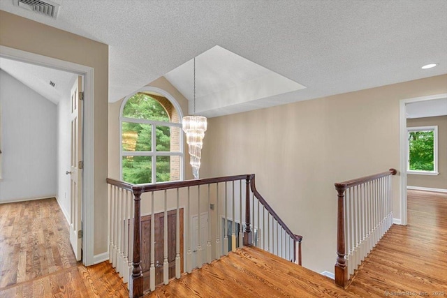1 Mountaincrest Dr, Cheshire, CT 06410 - staircase featuring a chandelier, plenty of natural light, wood finished floors, and a textured ceiling