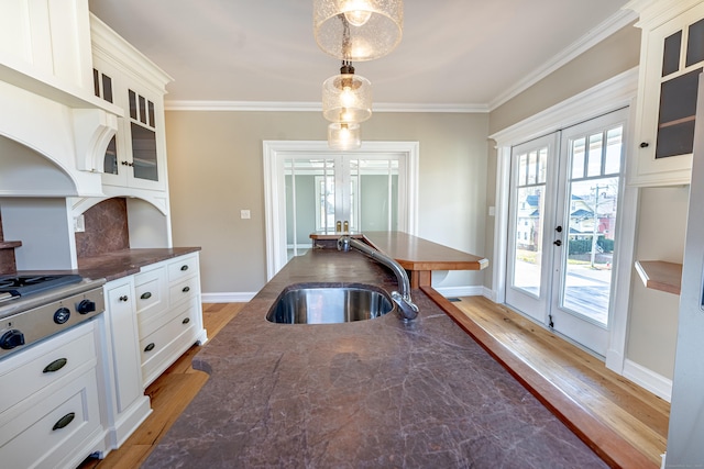 193 Woodland St, Bristol, CT 06010 - kitchen with french doors, light wood-style floors, crown molding, stainless steel cooktop, and hanging light fixtures