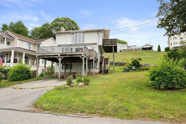 8 Griswold Dr, East Lyme, CT 06357 - view of front of home featuring driveway, a chimney, a front lawn, a deck, and a carport