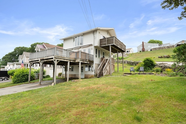 8 Griswold Dr, East Lyme, CT 06357 - back of property featuring a wooden deck, a yard, driveway, stairway, and a carport