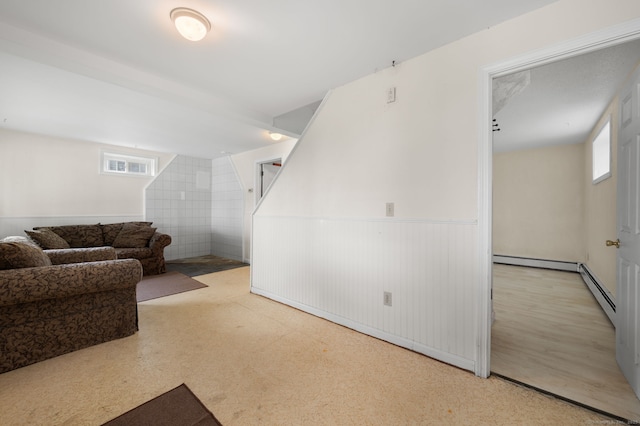 8 Griswold Dr, East Lyme, CT 06357 - living area with plenty of natural light, wainscoting, and baseboard heating
