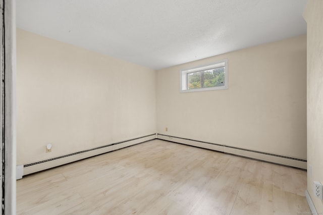8 Griswold Dr, East Lyme, CT 06357 - spare room with wood finished floors and a baseboard radiator