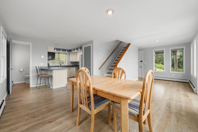 8 Griswold Dr, East Lyme, CT 06357 - dining space featuring healthy amount of natural light, stairway, light wood-style flooring, recessed lighting, and a baseboard radiator