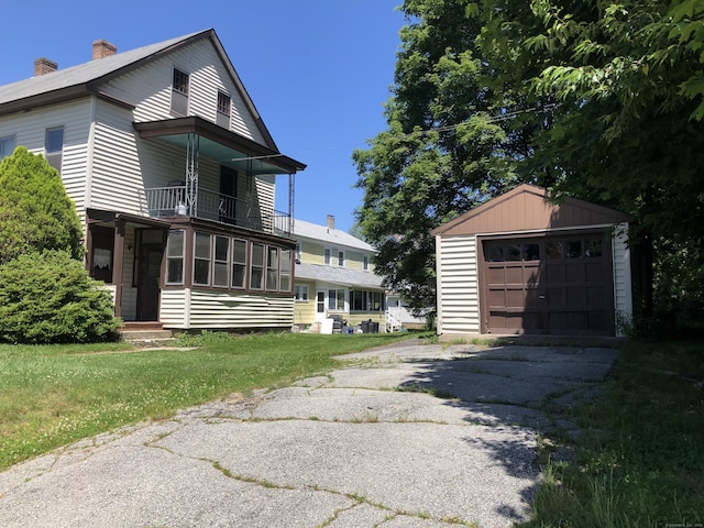 36 Connecticut Mills Ave, Killingly, CT 06239 - view of side of home with a balcony, an outdoor structure, driveway, a chimney, and a garage
