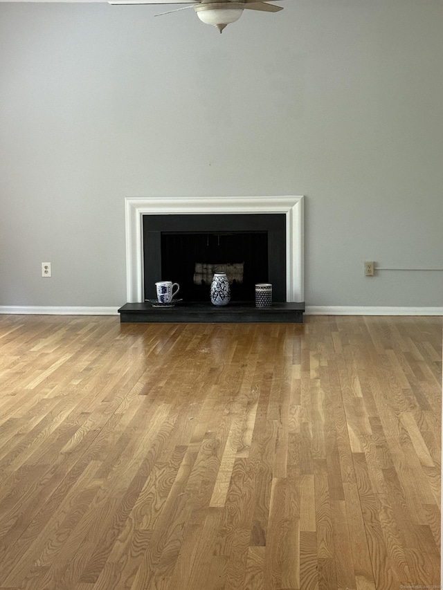 13 Hills Ln Unit 13, Westport, CT 06880 - detailed view of a ceiling fan, wood finished floors, and a fireplace with raised hearth