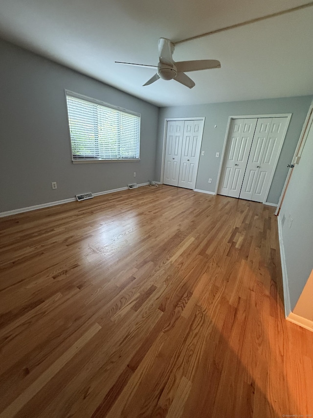 13 Hills Ln Unit 13, Westport, CT 06880 - unfurnished bedroom with multiple closets, wood finished floors, and ceiling fan