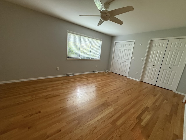 13 Hills Ln Unit 13, Westport, CT 06880 - unfurnished bedroom with multiple closets, light wood-style floors, and ceiling fan