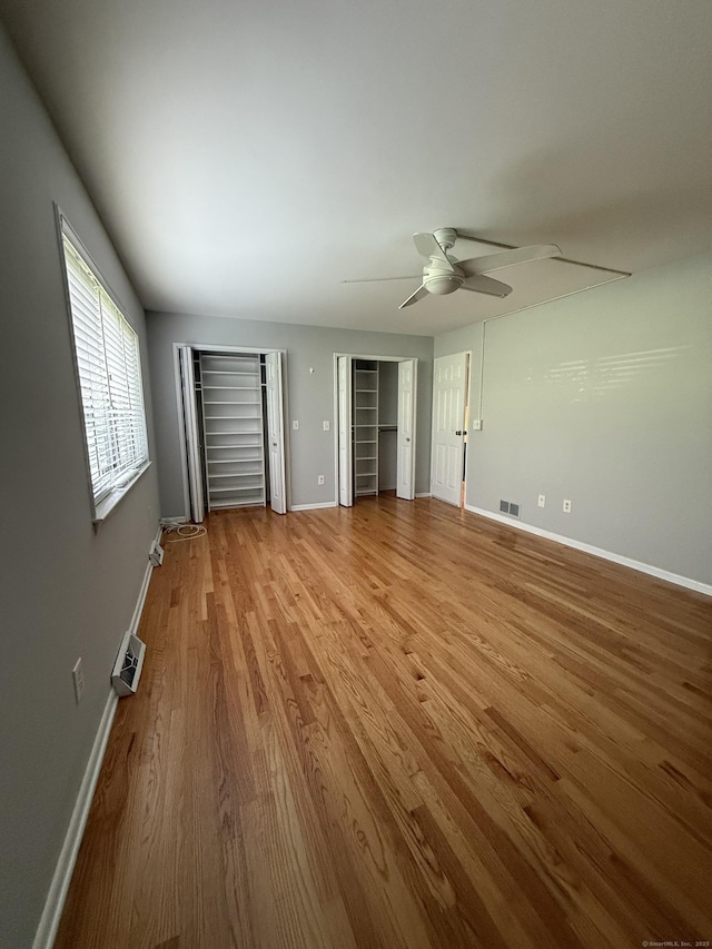 13 Hills Ln Unit 13, Westport, CT 06880 - unfurnished bedroom featuring wood finished floors, two closets, and ceiling fan