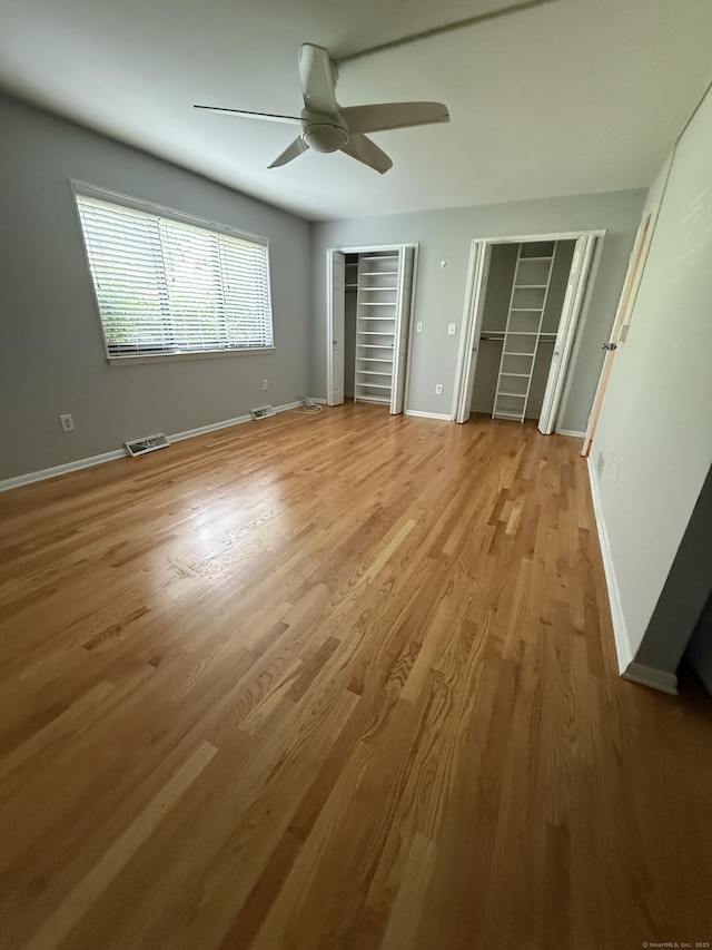 13 Hills Ln Unit 13, Westport, CT 06880 - unfurnished bedroom with multiple closets, wood finished floors, and ceiling fan