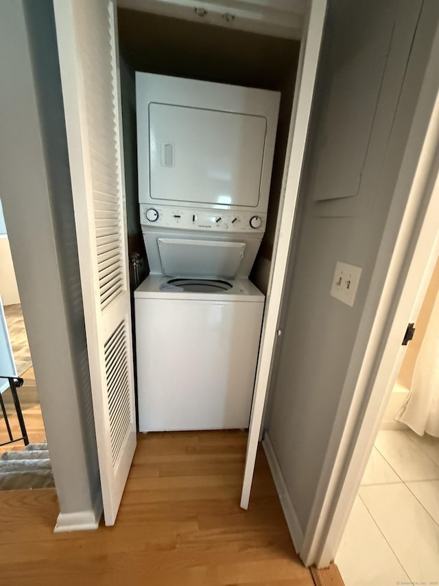 13 Hills Ln Unit 13, Westport, CT 06880 - laundry room with stacked washer and clothes dryer and light wood-type flooring