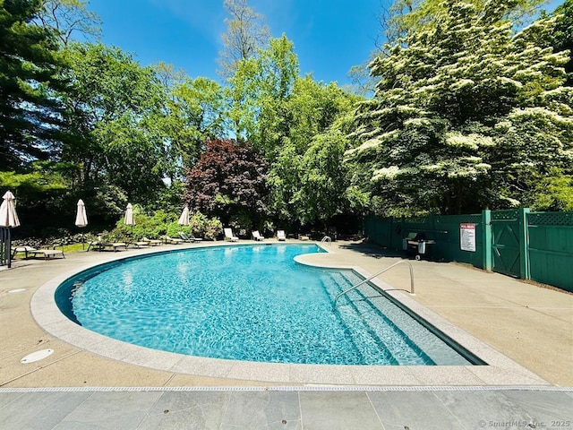 13 Hills Ln Unit 13, Westport, CT 06880 - community pool with a patio and view of scattered trees