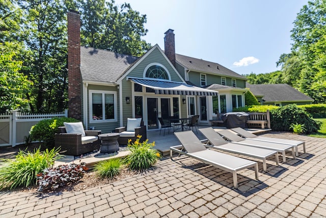 10 Brian Dr, Hebron, CT 06248 - back of property featuring an outdoor hangout area, outdoor dining space, a chimney, french doors, and a patio area