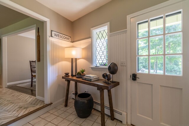 10 Brian Dr, Hebron, CT 06248 - foyer with plenty of natural light, light tile patterned floors, baseboard heating, and wainscoting