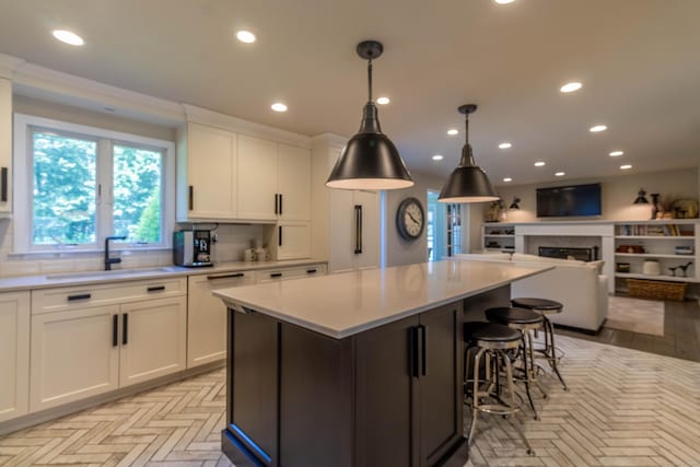 10 Brian Dr, Hebron, CT 06248 - kitchen featuring light countertops, white cabinets, open floor plan, recessed lighting, and a kitchen island