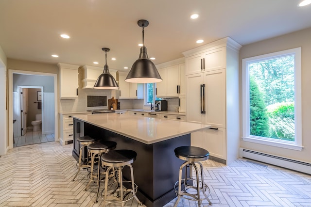 10 Brian Dr, Hebron, CT 06248 - kitchen featuring a center island, backsplash, a kitchen breakfast bar, white cabinetry, and recessed lighting