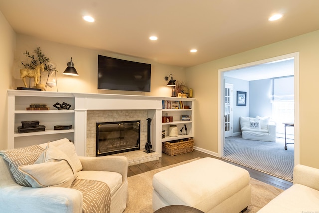 10 Brian Dr, Hebron, CT 06248 - living area with wood finished floors, recessed lighting, and a glass covered fireplace
