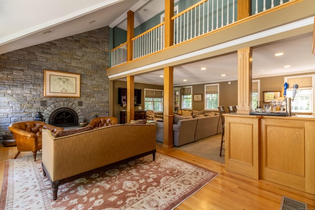 10 Brian Dr, Hebron, CT 06248 - living room featuring ornate columns, a stone fireplace, light wood finished floors, beam ceiling, and recessed lighting