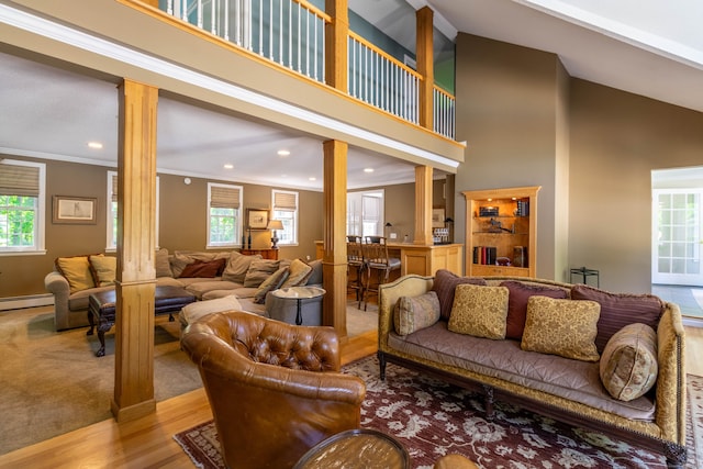 10 Brian Dr, Hebron, CT 06248 - living room with ornate columns, healthy amount of natural light, light wood finished floors, a baseboard radiator, and crown molding